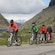 Four cyclists riding e bikes through a mountainous landscape in Haugesund
